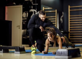 γυναίκα γυμνάζεται με τον προπονητή της
